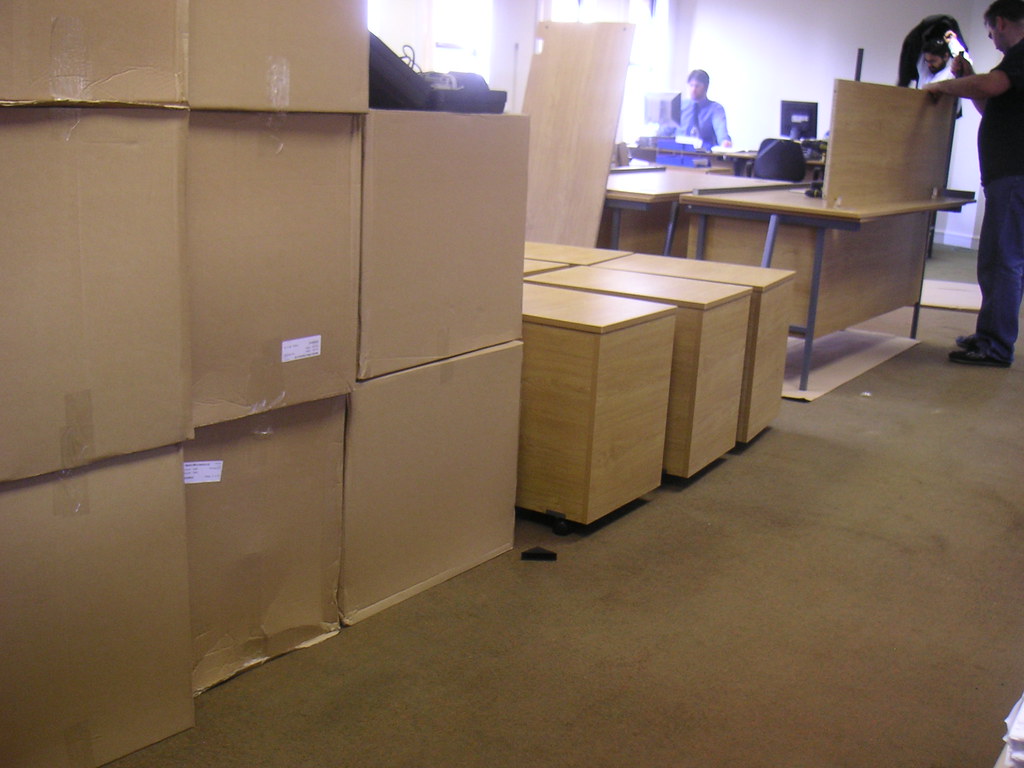 Office furniture and packed boxes during a workplace move